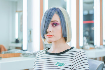 Woman using a hair straightener to achieve sleek, frizz-free hair.