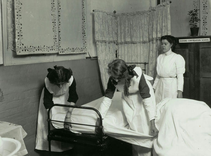 Woman using a straightener on long, shiny hair, demonstrating proper hair care technique before heat styling.