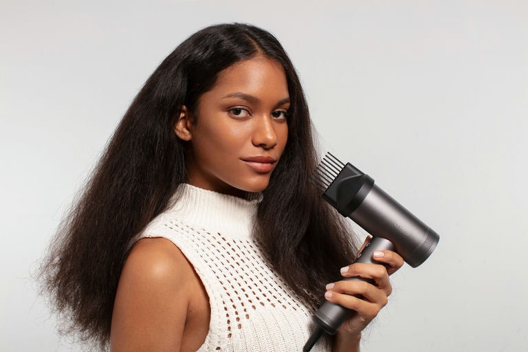 Woman using professional-grade hair care tools at home for hair care routine